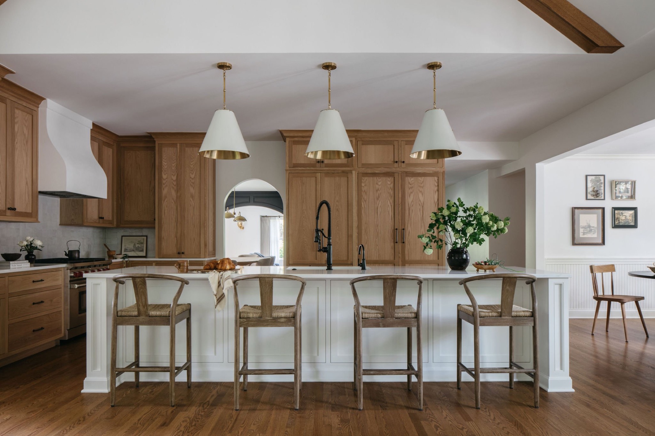 White oak kitchen with vaulted ceiling and pendant trio by Leah Phillips Interiors