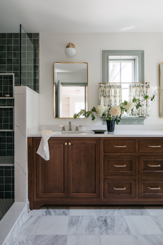 Bathroom with dark walnut vanity and green zellige tile shower designed by Leah Phillips Interiors