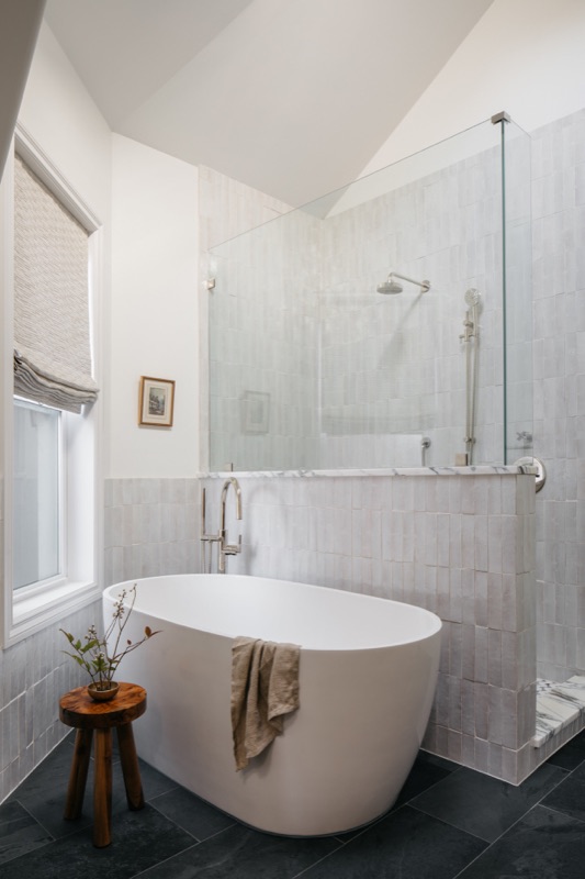 Freestanding oval tub beside the glass shower · Bathroom Renovations