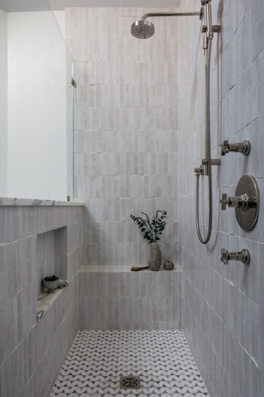 Marble mosaic walk-in shower with black accents · Bathroom Renovations by Leah Phillips Interiors