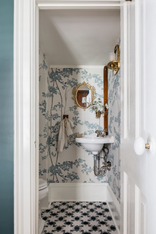 Powder room with blue chinoiserie wallpaper and wall-mount sink · Bathroom Renovations