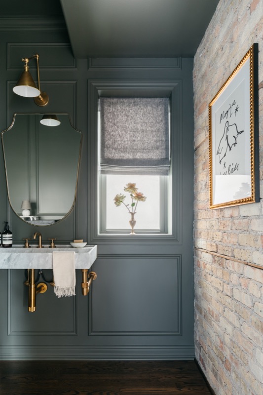 Moody green powder room with stone accent wall · Bathroom Renovations by Leah Phillips Interiors