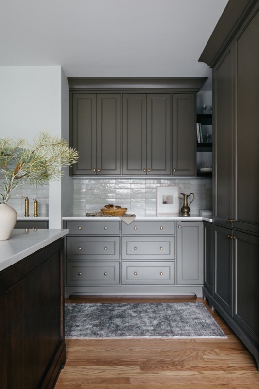 Charcoal cabinetry with vintage runner and white counters · Downers Grove Main Level Renovation by Leah Phillips Interiors