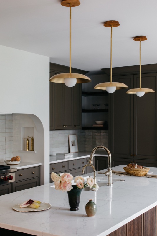 Marble-topped island with brass dome pendants and blooms · Downers Grove Main Level Renovation by Leah Phillips Interiors