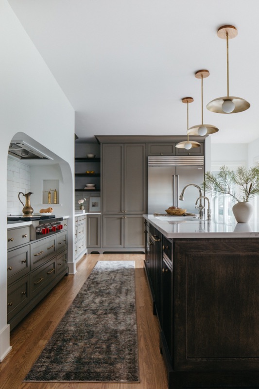 Galley view of the charcoal kitchen toward the window · Downers Grove Main Level Renovation by Leah Phillips Interiors