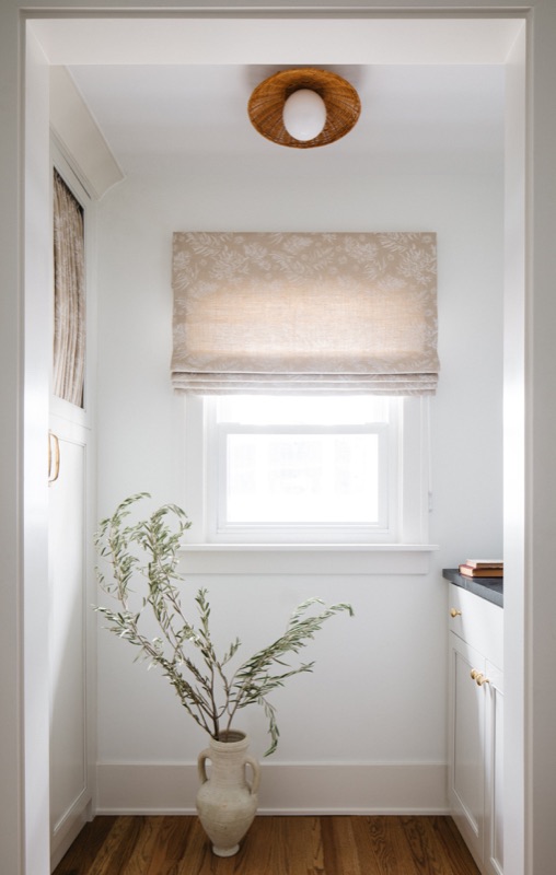 Mudroom nook with bench and soft patterned shade · Downers Grove Main Level Renovation by Leah Phillips Interiors