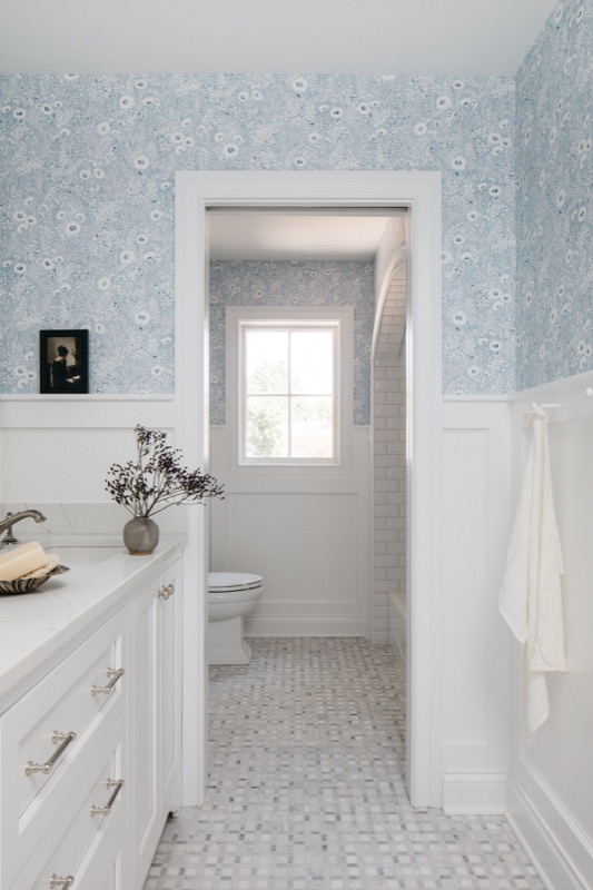 Hall bathroom with soft blue block print wallpaper · Glen Ellyn Kitchen & Bathroom Renovation by Leah Phillips Interiors