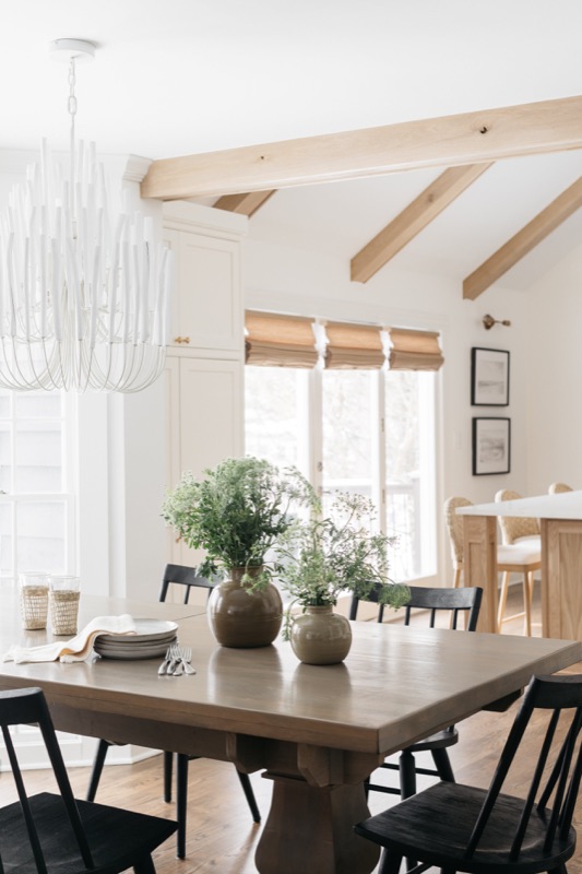 Dining area with farm table and black windsor chairs · Glen Ellyn Main Level Renovation by Leah Phillips Interiors