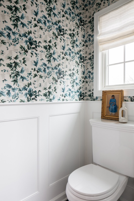 Powder room with green floral wallpaper and wainscot · Glen Ellyn Main Level Renovation by Leah Phillips Interiors