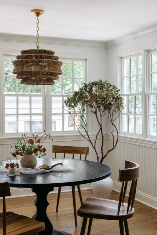 Breakfast nook with round black table and woven pendant · Glenview Home Renovation by Leah Phillips Interiors