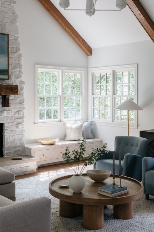 Family room window seat with layered blue seating · Glenview Home Renovation by Leah Phillips Interiors
