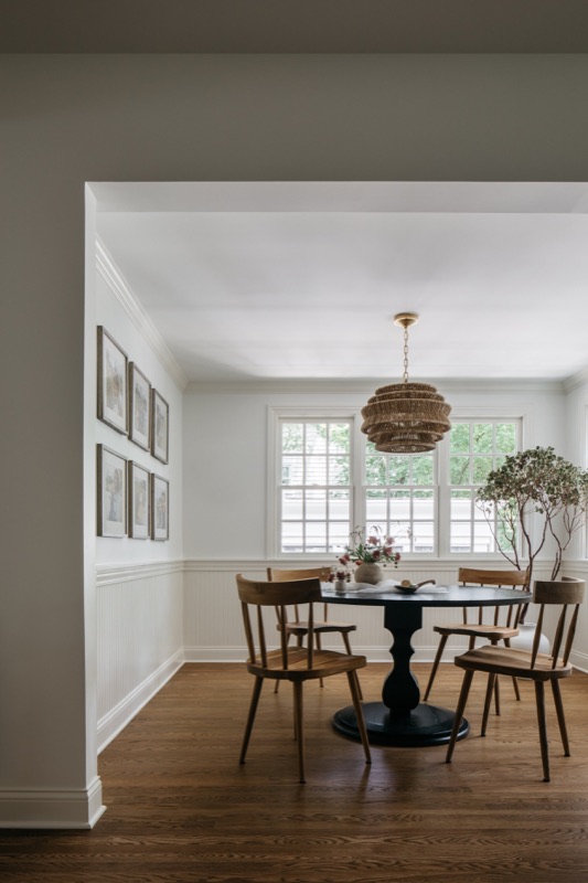 Casual dining area with vintage-style black table · Glenview Home Renovation by Leah Phillips Interiors