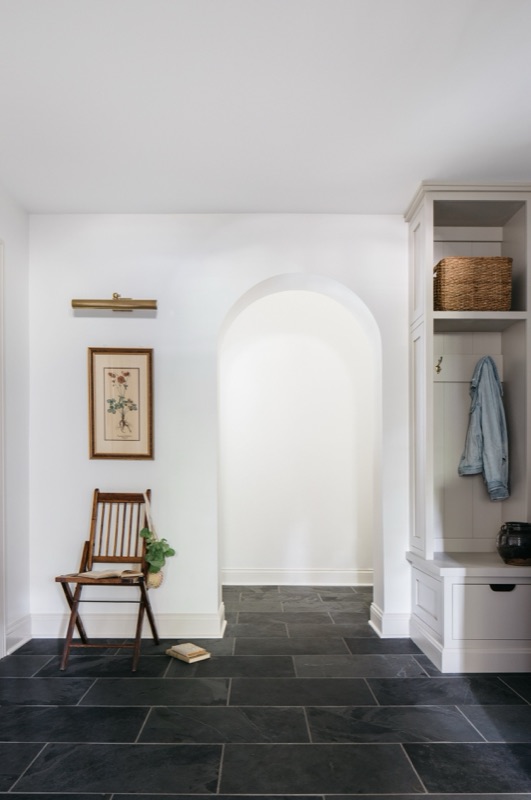 Entry hall with slate floors and arched display niche · Glenview Home Renovation by Leah Phillips Interiors