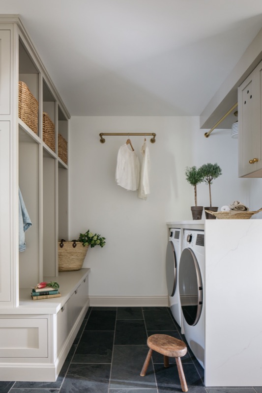 Mudroom laundry with open cubbies and drying rod · Glenview Home Renovation by Leah Phillips Interiors