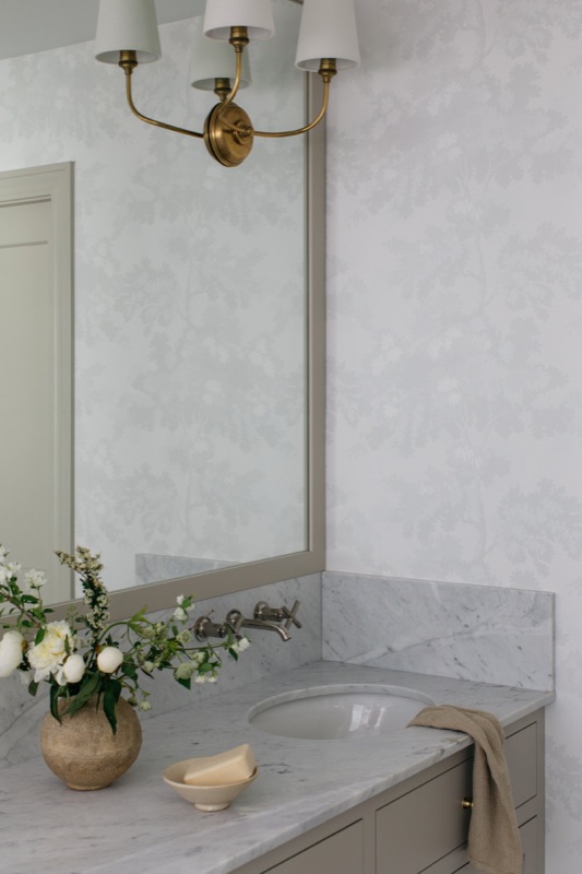 Primary bath vanity with limestone-look surround · Glenview Home Renovation by Leah Phillips Interiors