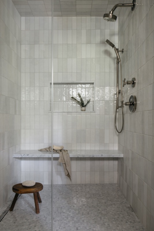 Walk-in shower with large format tile and mosaic floor · Glenview Home Renovation by Leah Phillips Interiors