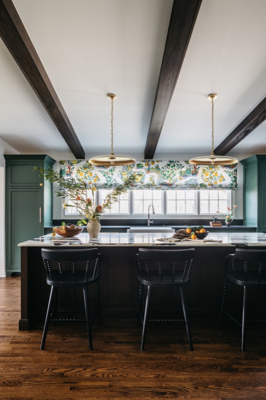 Kitchen with dark beams and brass chandelier over the island · Glenview Kitchen Addition & Renovation by Leah Phillips Interiors