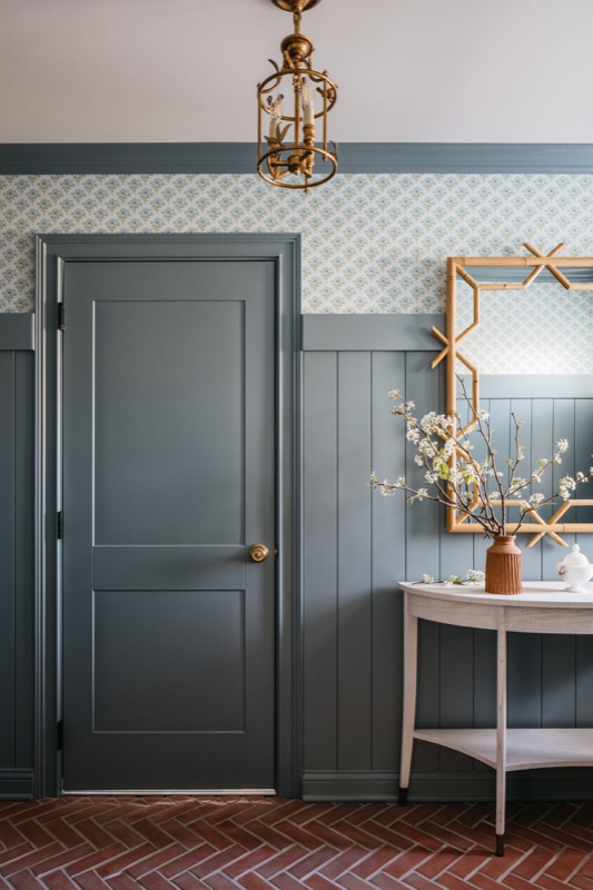 Powder room with slate blue console vanity and gold mirror · Glenview Kitchen Addition & Renovation by Leah Phillips Interiors