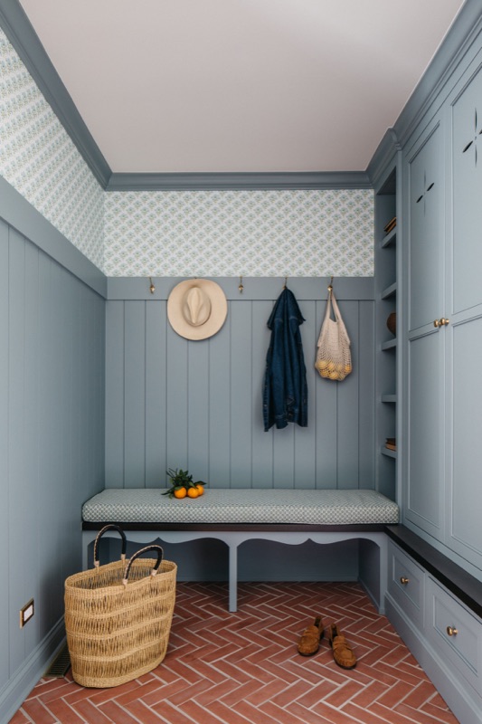 Mudroom bench wall with hooks and woven baskets · Glenview Kitchen Addition & Renovation by Leah Phillips Interiors