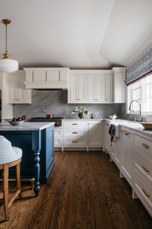 Cream inset cabinetry along the range wall with soft gray backsplash · Glenview Main Level Renovation by Leah Phillips Interiors