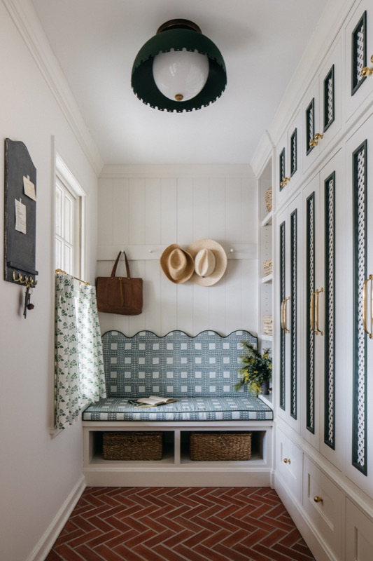 Mudroom built-ins with mesh cabinet fronts and seasonal wreath · Glenview Main Level Renovation by Leah Phillips Interiors