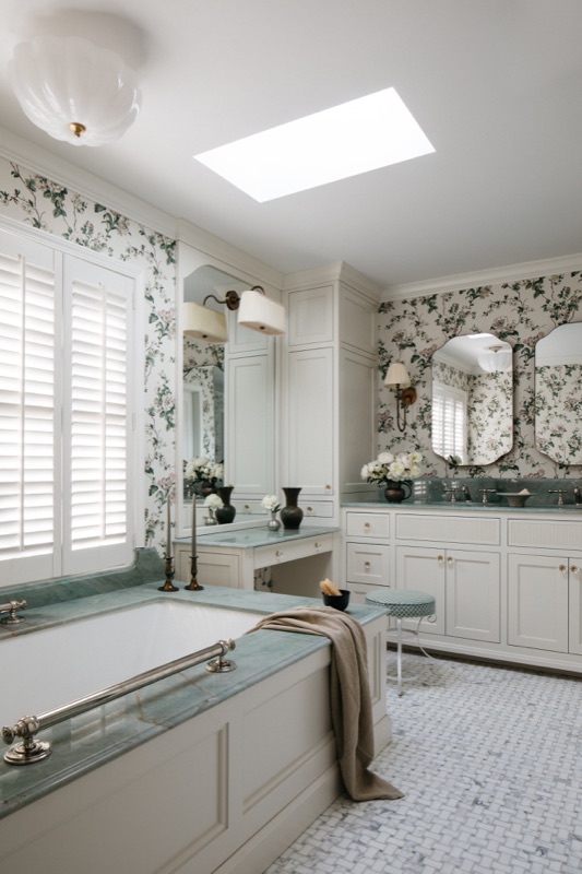 Primary bath with skylight over the soaking tub · Glenview Main Level Renovation by Leah Phillips Interiors