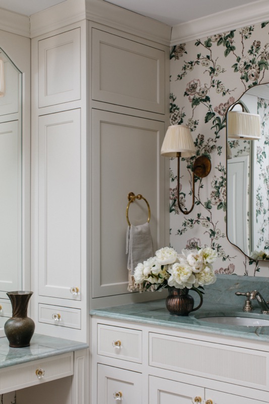 Makeup vanity with brass sconce and green quartzite top · Glenview Main Level Renovation by Leah Phillips Interiors