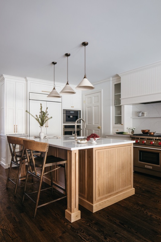Kitchen with white oak island and trio of brass pendants · Lincoln Park Main Level Renovation by Leah Phillips Interiors