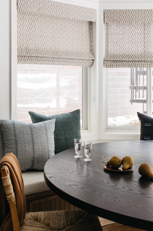 Bay window banquette with round black dining table · Lincoln Park Main Level Renovation