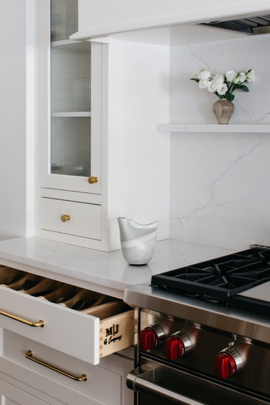Range detail with pot drawers and marble ledge · Lincoln Park Main Level Renovation by Leah Phillips Interiors