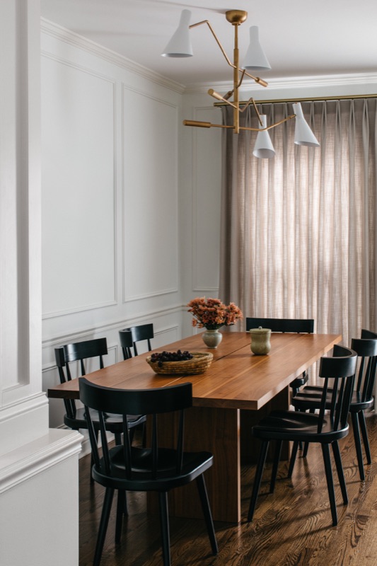 Dining area with wood table and black spindle chairs · Lincoln Park Main Level Renovation by Leah Phillips Interiors