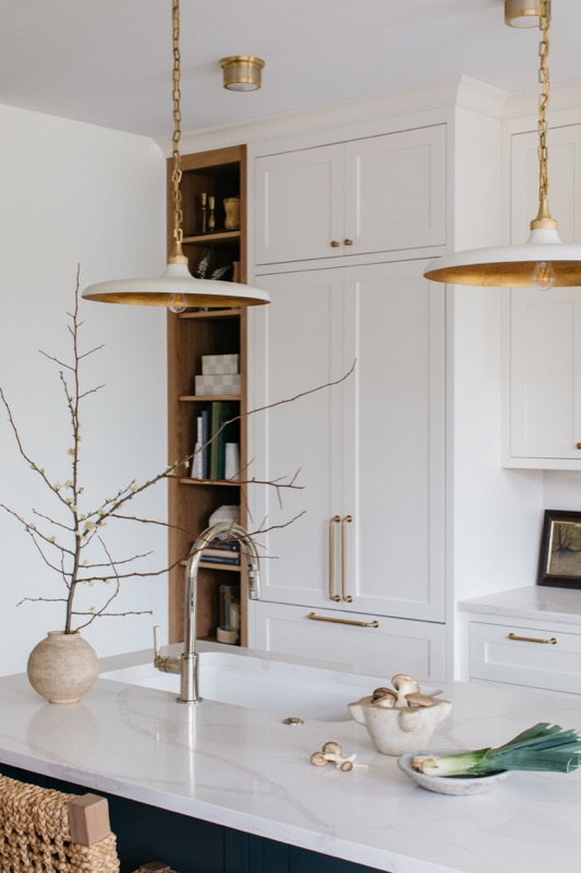Glass-front uppers styled with everyday ceramics · Lincoln Park Renovation by Leah Phillips Interiors