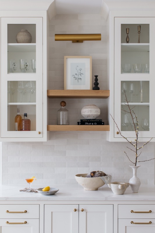 Coffee bar with glass cabinets and marble counter · Lincoln Park Renovation by Leah Phillips Interiors