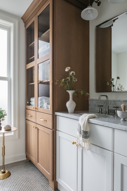 Bathroom with white oak tall cabinet and double vanity · Lincoln Park Renovation by Leah Phillips Interiors