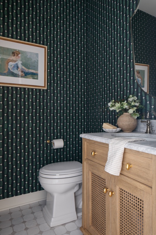 Powder room with green patterned wallpaper and oak vanity · Lincoln Park Renovation