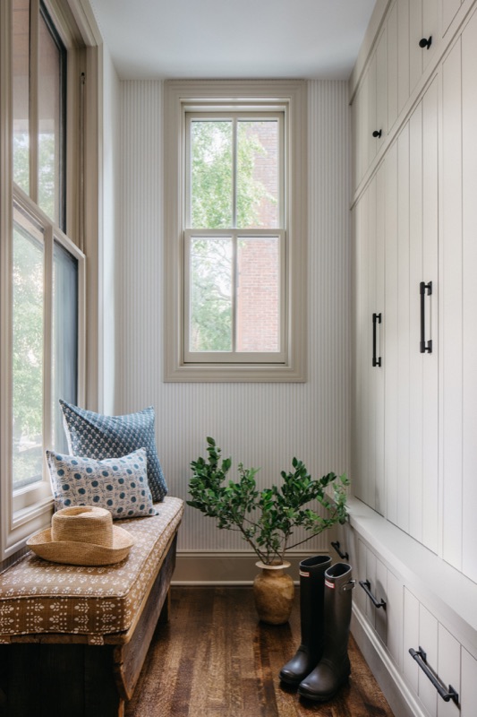Mudroom corner with built-in bench and woven baskets · Oak Park Main Level Renovation by Leah Phillips Interiors
