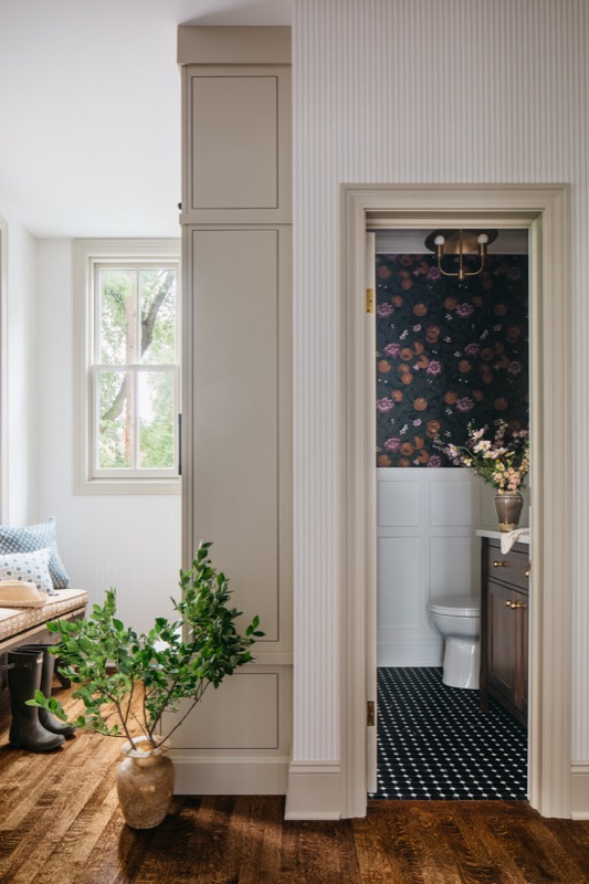 Hall view into the powder room with dark botanical walls · Oak Park Main Level Renovation by Leah Phillips Interiors