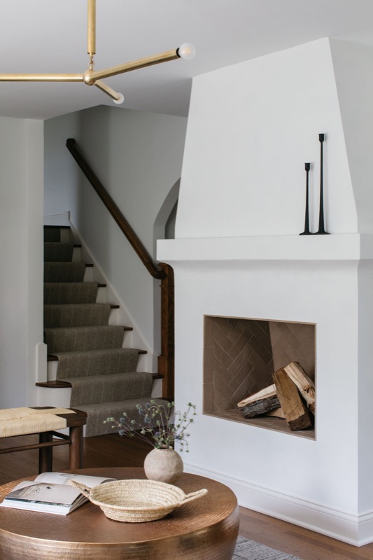 Sculptural plaster fireplace beside the staircase · a recent Glenview transformation by Leah Phillips Interiors